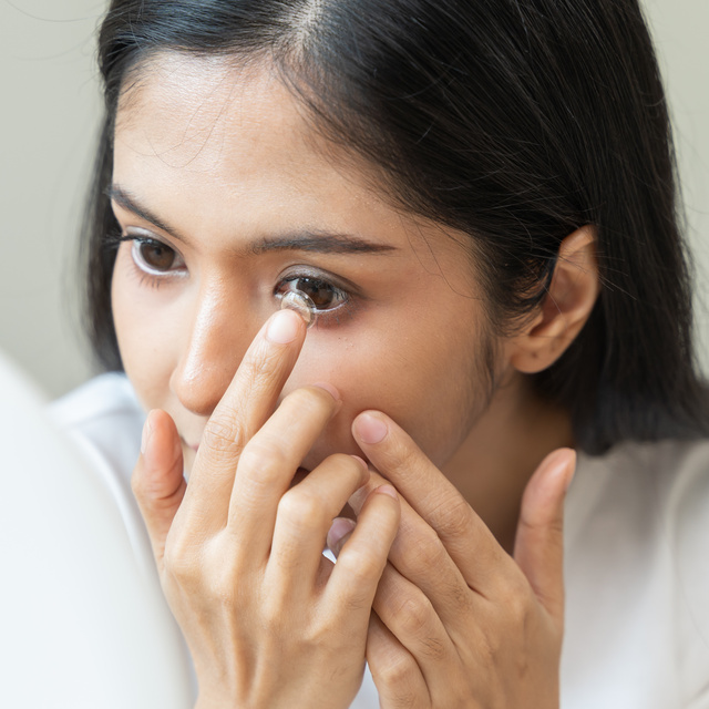 woman putting in contact